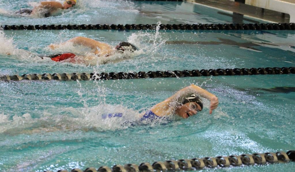Summit Swim team members race down the pool during a meet.